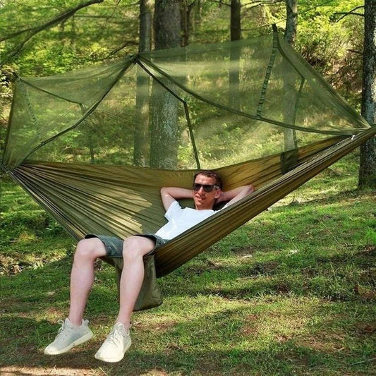 Portable outdoor camping hammock with integrated mosquito net, ideal for safe relaxation.