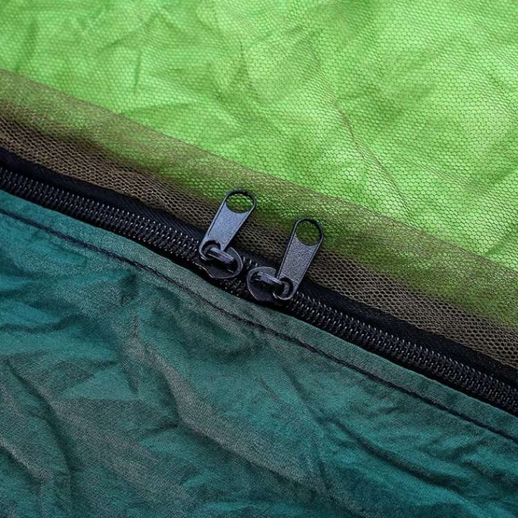 Travel-friendly portable hammock for hiking and camping, includes attached bug net.