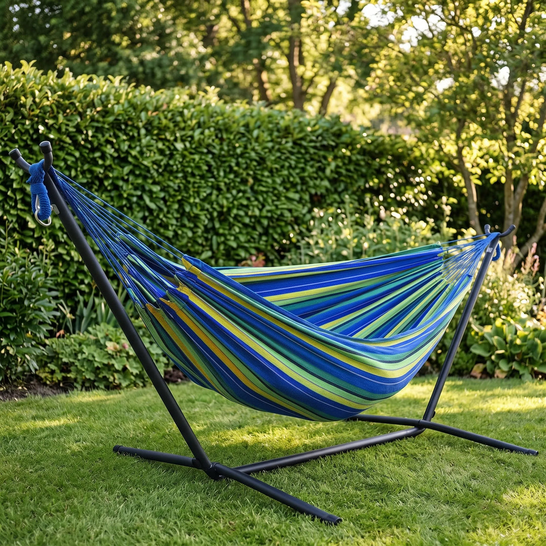 Relaxing striped canvas hammock for camping, garden, or backyard. Comfortable outdoor furniture for travel.