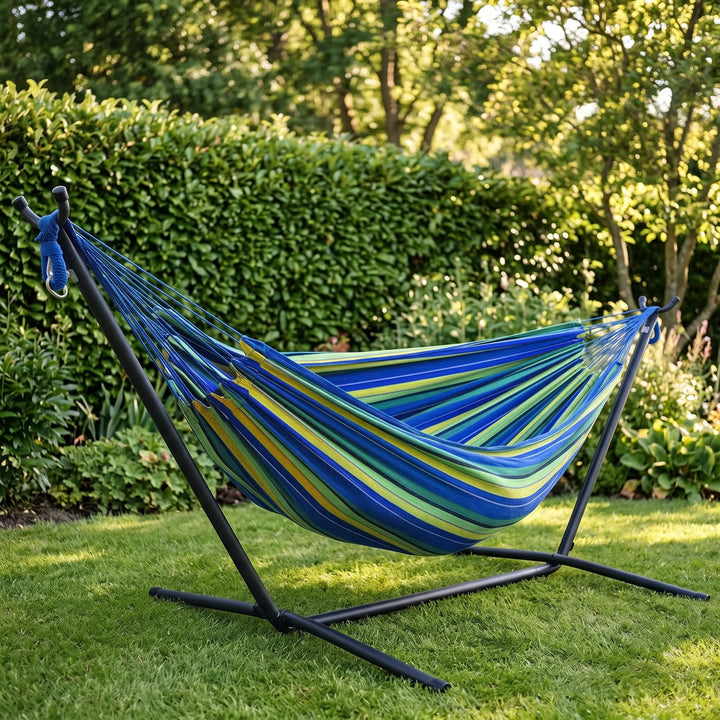 Relaxing striped canvas hammock for camping, garden, or backyard. Comfortable outdoor furniture for travel.