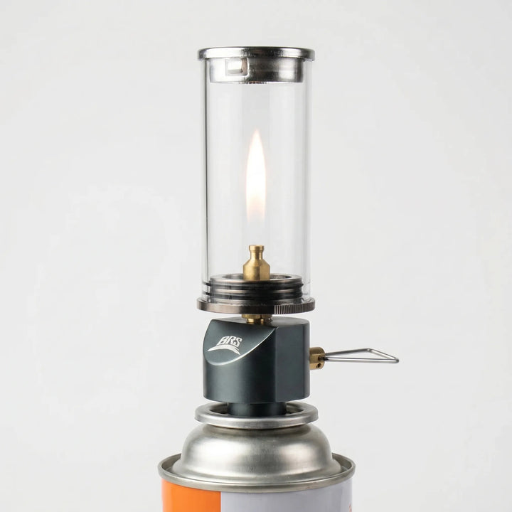 Portable windproof gas candle lantern for camping & hiking adventures. Ideal outdoor tent light.