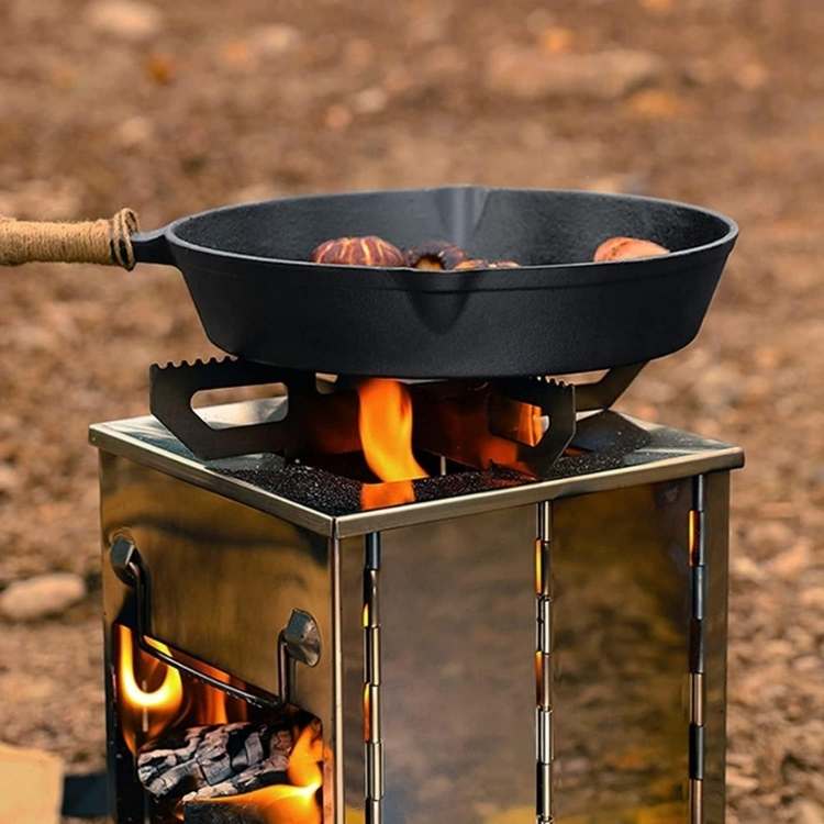 Compact wood burning hiking gear stove, disassembled for easy portability in a backpack