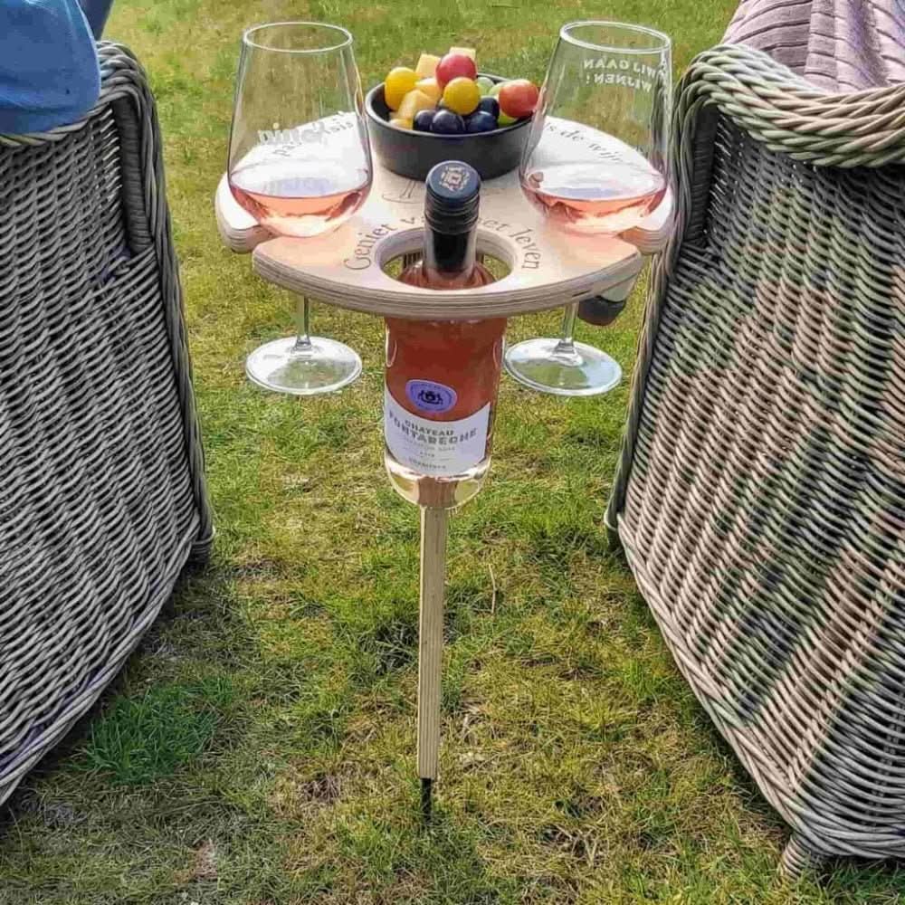 Portable wooden wine table for picnics, outdoor dining, and beach gatherings. Includes wine glass slots & snack tray.