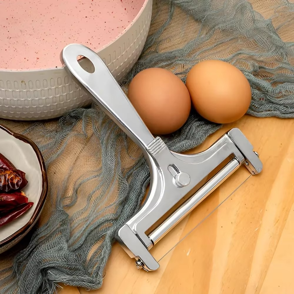 Adjustable thickness cheese slicer, stainless steel design, ensures perfect slices for all cheese types.