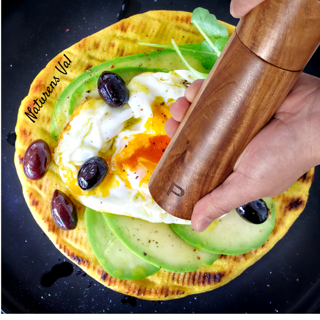 Ergonomic handle of a teak wood kitchen utensil, comfortable & durable cooking tool.