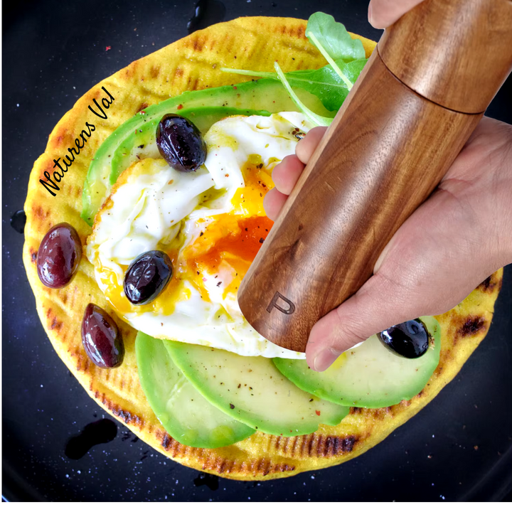 Ergonomic handle of a teak wood kitchen utensil, comfortable & durable cooking tool.