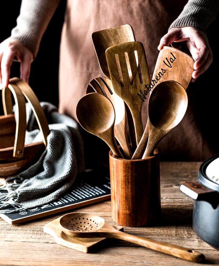 Teak wood kitchen utensil set neatly arranged on a modern kitchen counter.