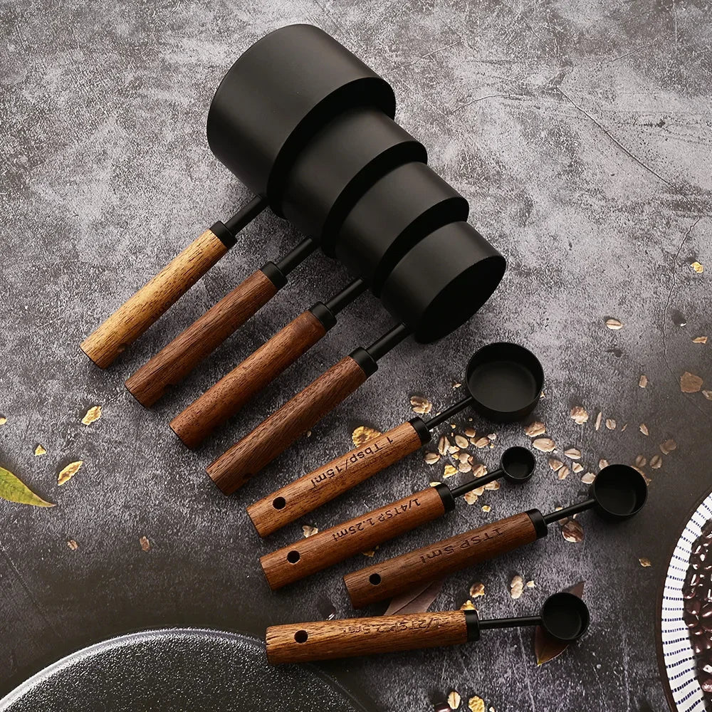 Professional stainless steel measuring spoon set with elegant wooden handles for precise cooking.