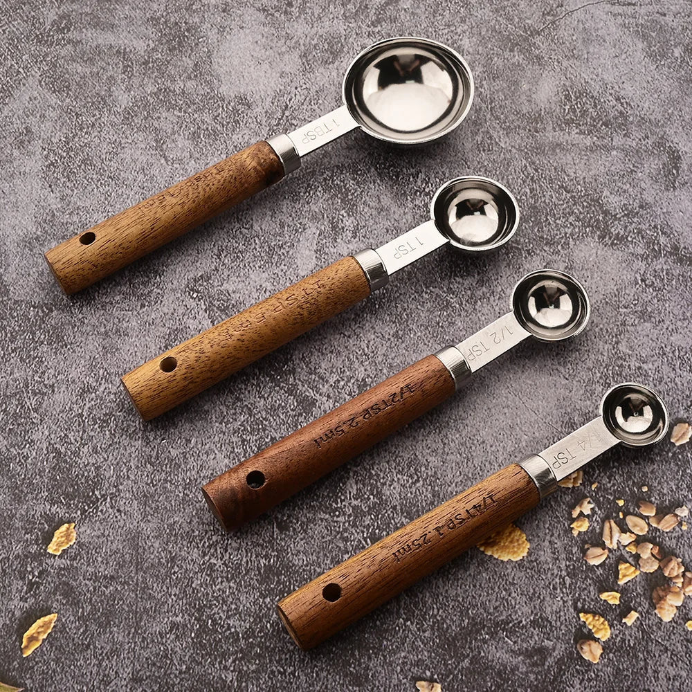 Professional stainless steel measuring spoon set with wooden handles, ideal for precise baking and cooking.