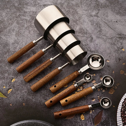 Stylish professional stainless steel measuring spoon set with wooden handles, great kitchen decor.