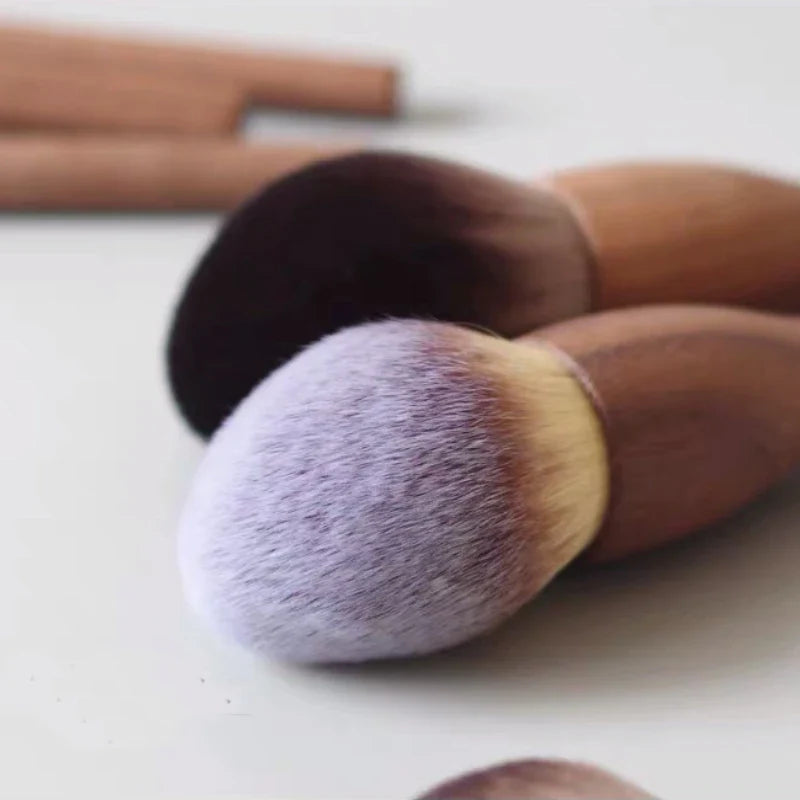Elegant walnut handle professional vegan makeup brushes, essential cosmetic tools for precise beauty application.