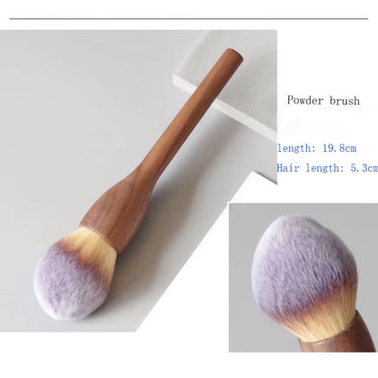 Close-up of professional vegan makeup brushes, natural walnut handles and soft synthetic bristles.