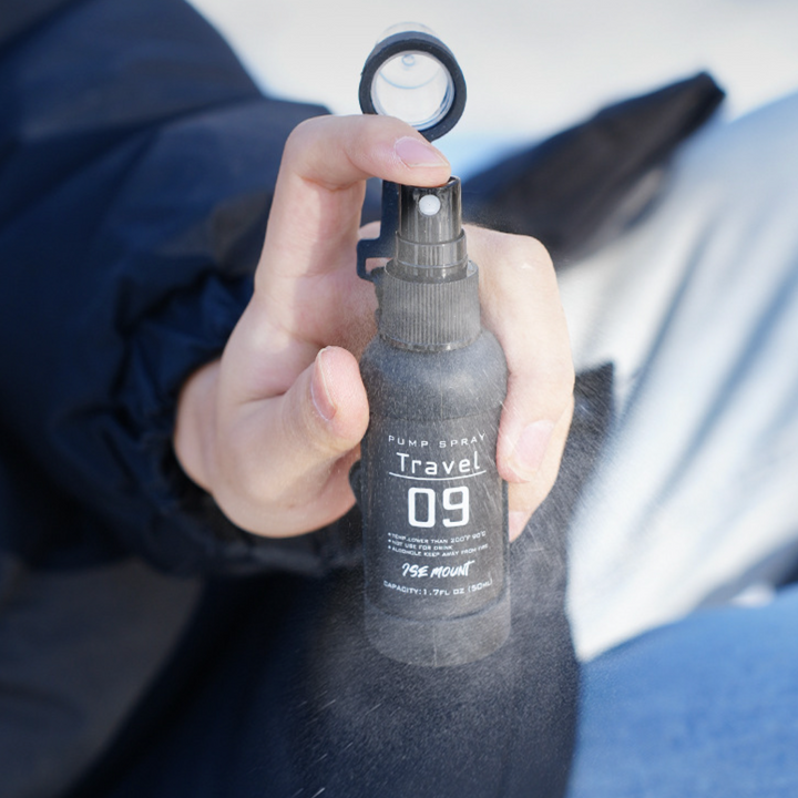 Unisex QuickMist spray bottle set in a hand, showcasing its portable design for hiking & camping