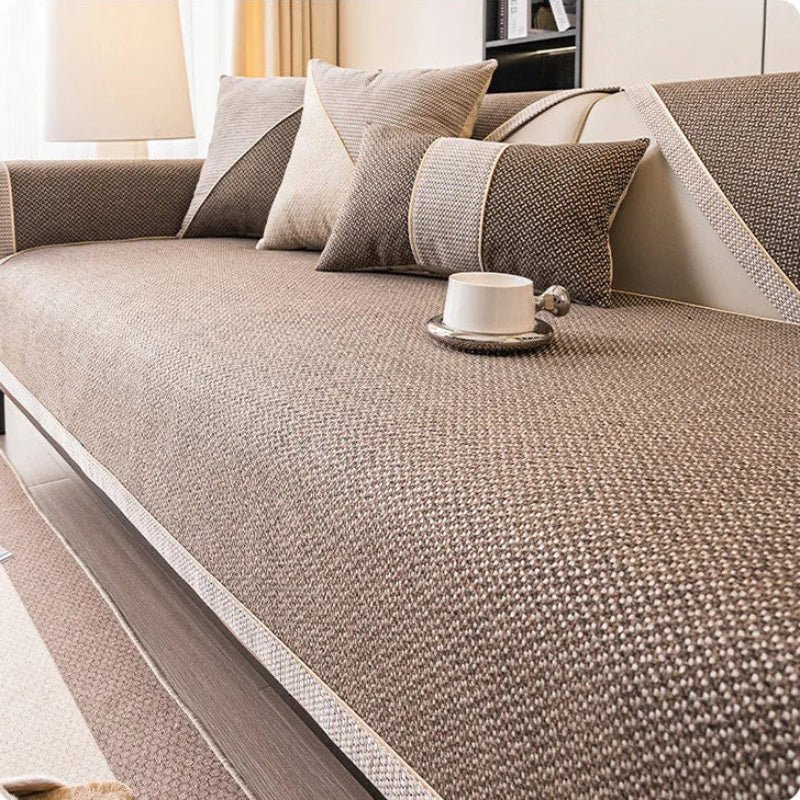 Easy-to-install non-slip sofa cover, draping over a couch, showing a snug, protective fit.