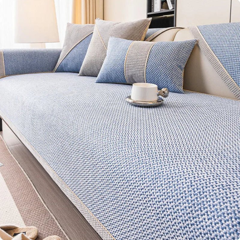 Neutral beige cotton-linen non-slip sofa protector. Versatile quilted throw complementing home decor.