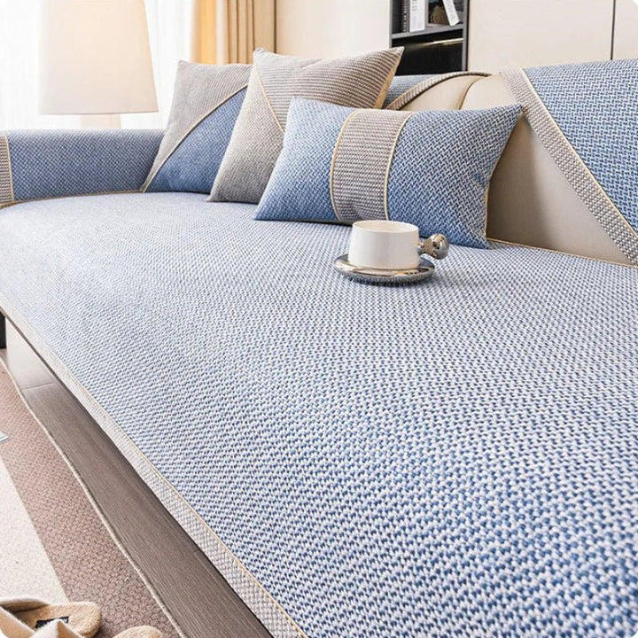 Neutral beige cotton-linen non-slip sofa protector. Versatile quilted throw complementing home decor.