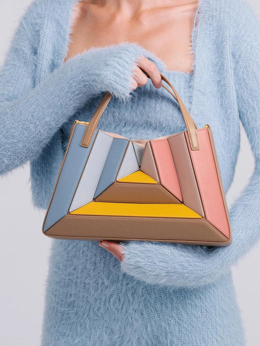 Radiant women's architectural sculptural handbag in luxury vegan leather. Unique geometric design, top handle & crossbody options.