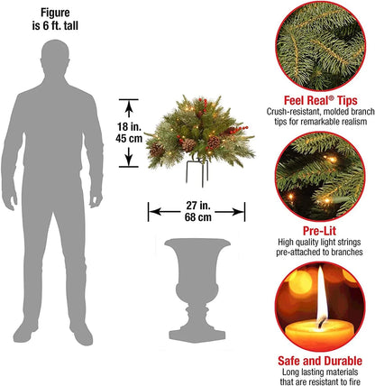 Pre-lit 'Feel Real' artificial Christmas urn filler with pinecones, red berries, and warm white LED lights.