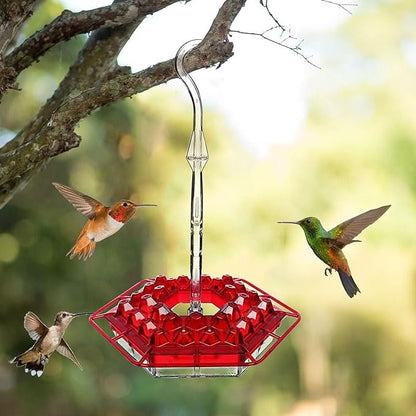 Red ant-proof hanging hummingbird feeder for outdoor gardens, attracting birds with sweet nectar.