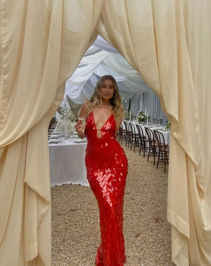 Stunning red sequin homecoming dress, a backless V-neck mermaid style perfect for prom & formal wear.