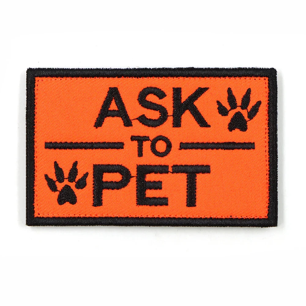 Owner attaching a 'SERVICE DOG' patch to a dog's harness, illustrating ease of use for pet identification