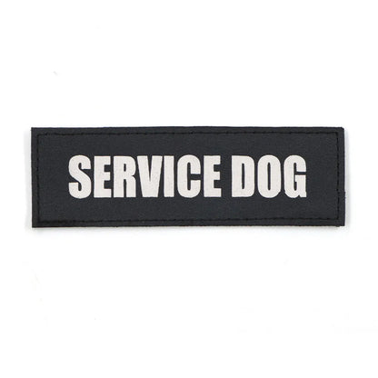 Dog wearing a harness with an attached 'SERVICE DOG' patch, demonstrating real-world use for identification