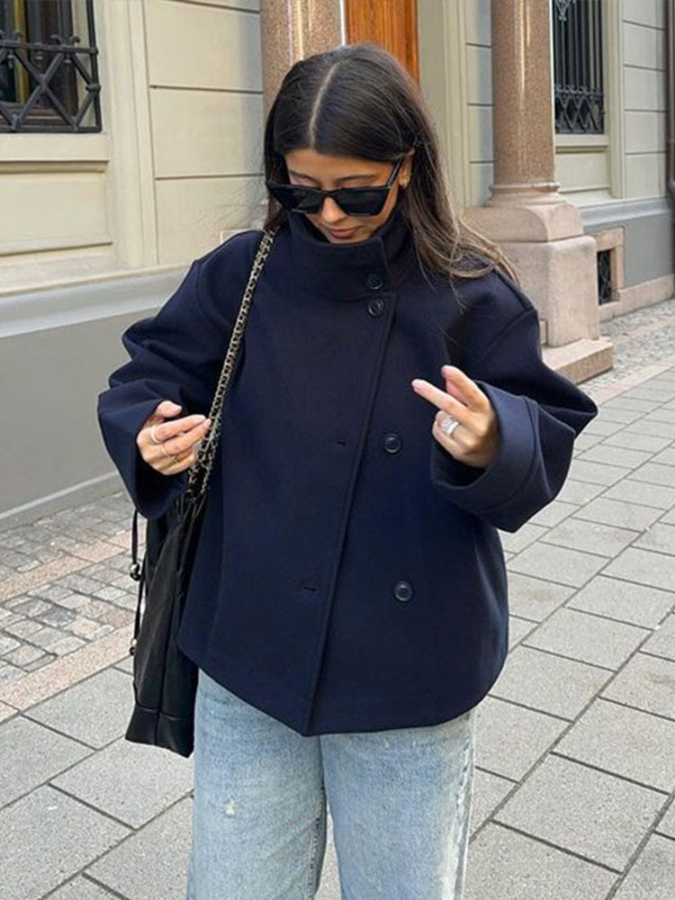 Stylish women's relaxed fit short coat with high neck and button closure, ideal layering piece for fall/winter.