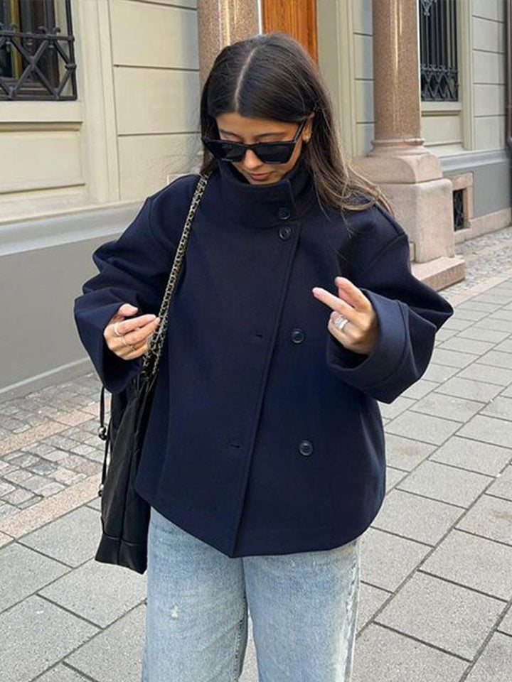 Stylish women's relaxed fit short coat with high neck and button closure, ideal layering piece for fall/winter.
