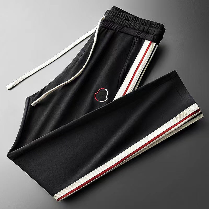 Men's deep black activewear tracksuit, featuring Aero Fit design for optimal movement & performance.