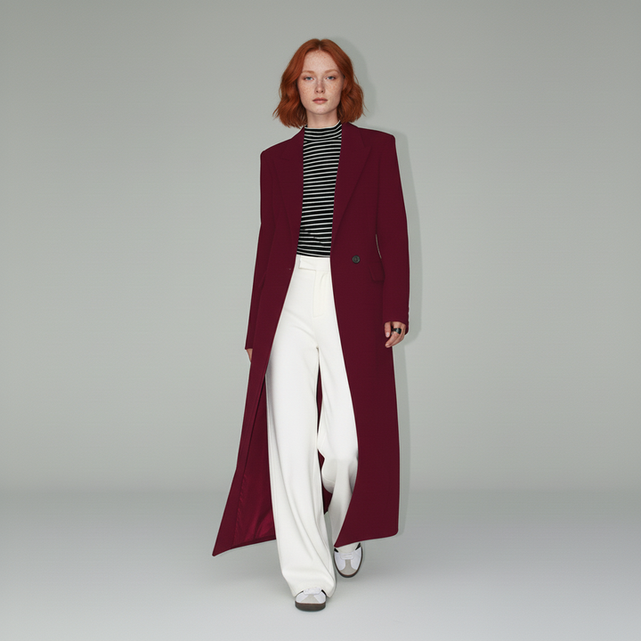 Stylish ruby red women's long fitted tailored coat. Modern, minimalist city outerwear.