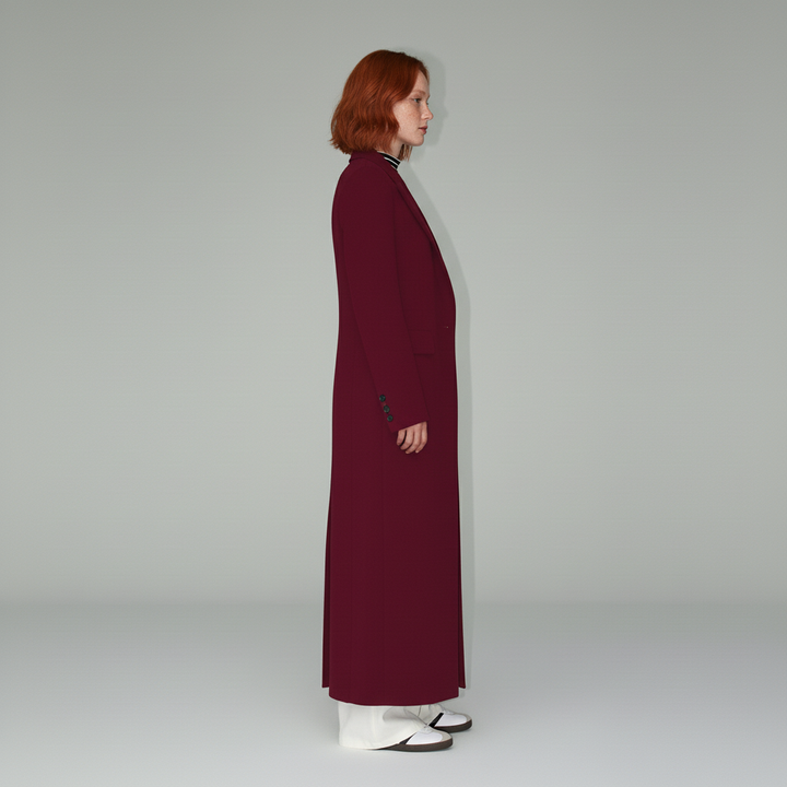 Long ruby tailored coat for women, a sophisticated fitted piece. Elegant fashion outerwear.