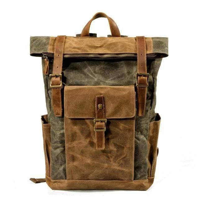 Traveler wearing a vintage canvas leather backpack in a scenic area.