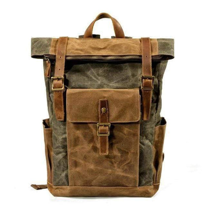 Traveler wearing a vintage canvas leather backpack in a scenic area.