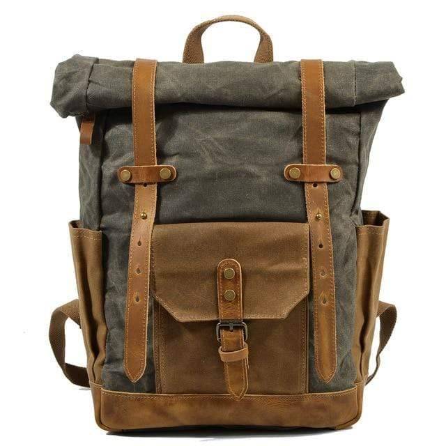 Empty rugged men's vintage canvas leather backpack, studio shot.