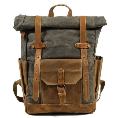 Empty rugged men's vintage canvas leather backpack, studio shot.