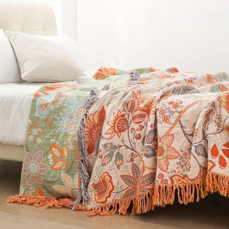 Soft cotton throw blanket with a rustic floral boho pattern, perfect for cozying up.