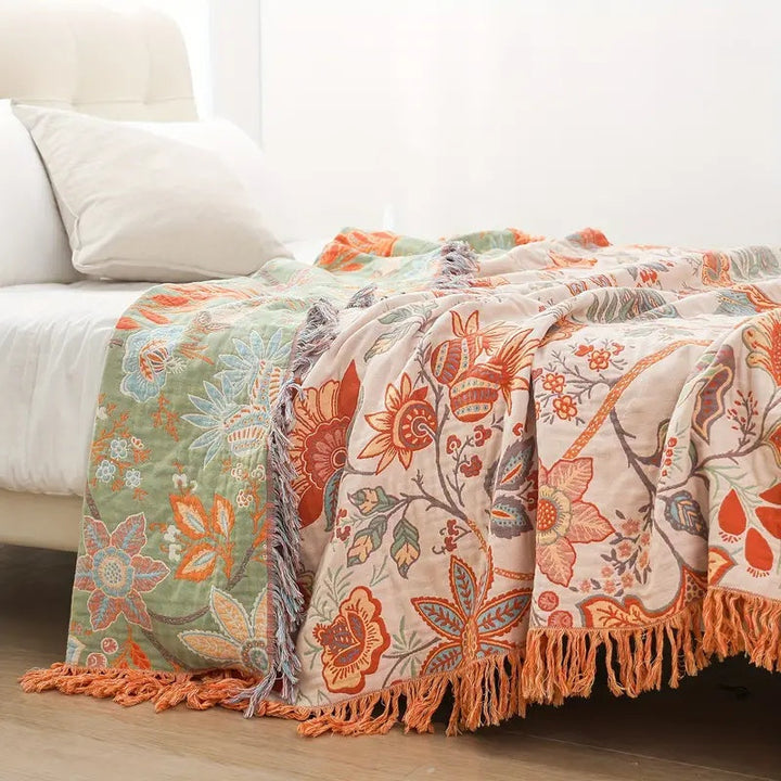 Soft cotton throw blanket with a rustic floral boho pattern, perfect for cozying up.