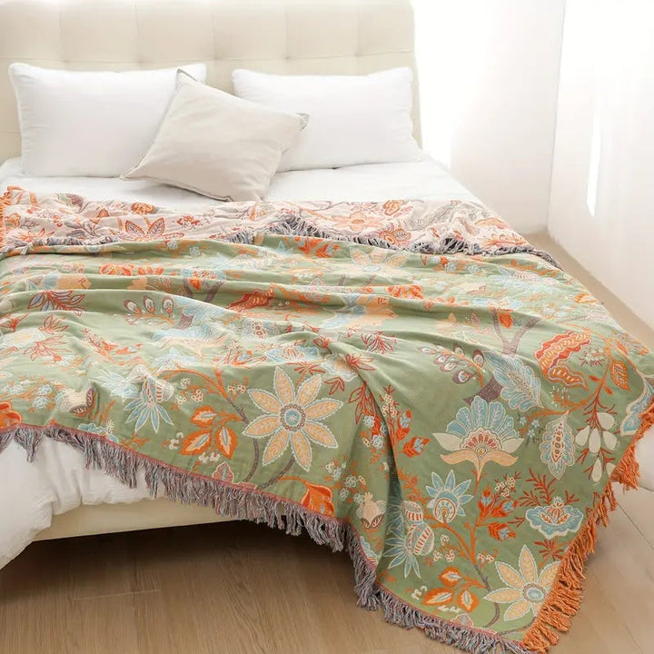 Elegant bohemian cotton blanket with a rustic floral motif, an inviting and cozy throw.