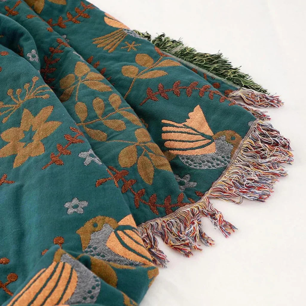 Living room accent: reversible Scandinavian bird blanket, soft cotton throw with nature-inspired design.