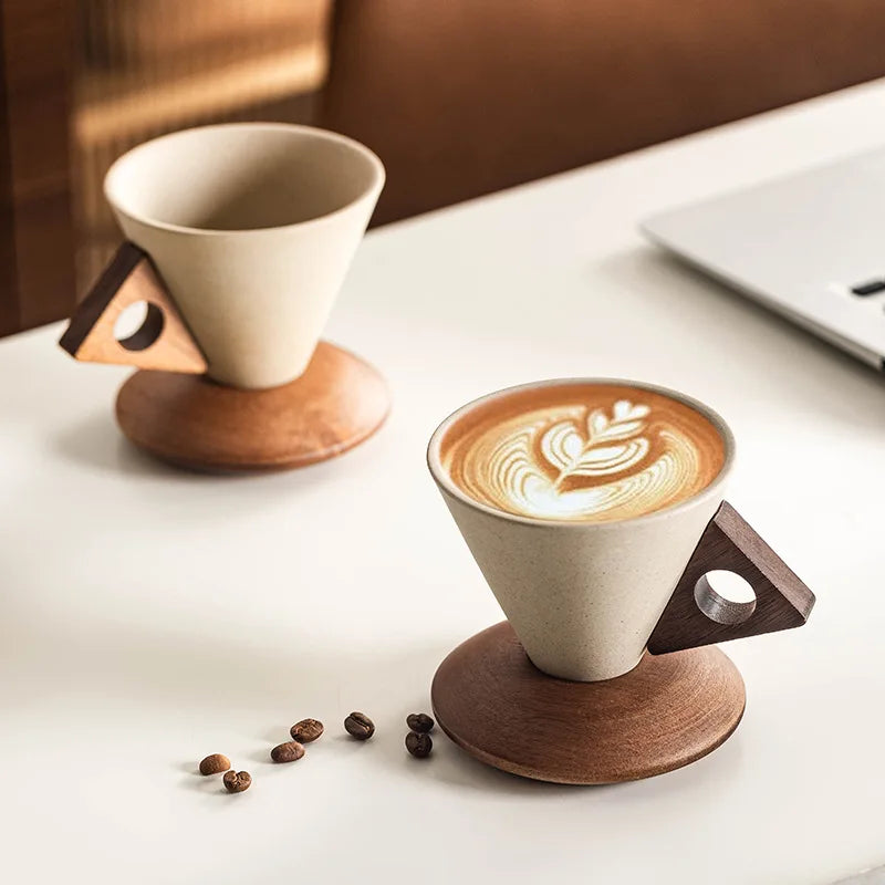 Sculptural ceramic coffee cups with unique cone design & wood base. Modern kitchenware for home decor.