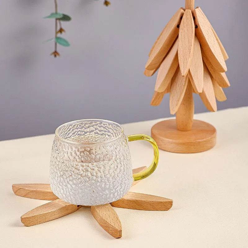 Close-up of 4 walnut wood coasters & trivets. Tree design natural heat pads for table protection & decor.