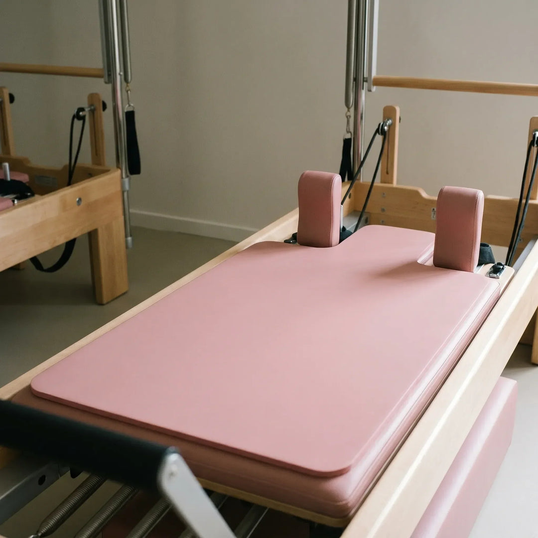 Shaped Pilates reformer pad for comfortable, non-slip studio sessions. Unisex exercise mat accessory.