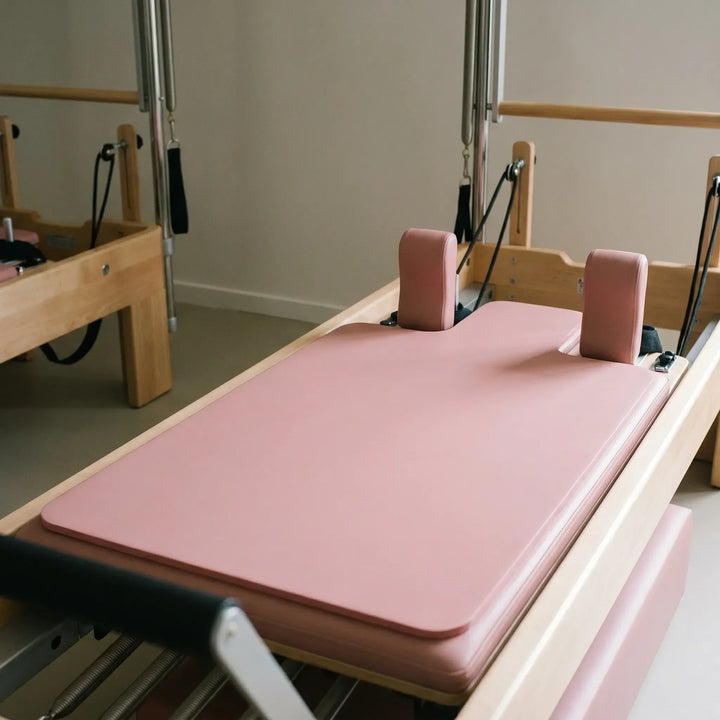 Shaped Pilates reformer pad for comfortable, non-slip studio sessions. Unisex exercise mat accessory.