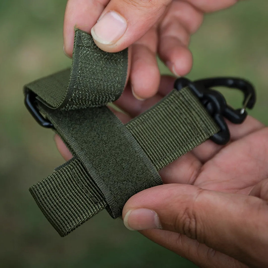 Tactical clip used to secure a water bottle, showcasing its versatility beyond just glove holding as emergency tool.