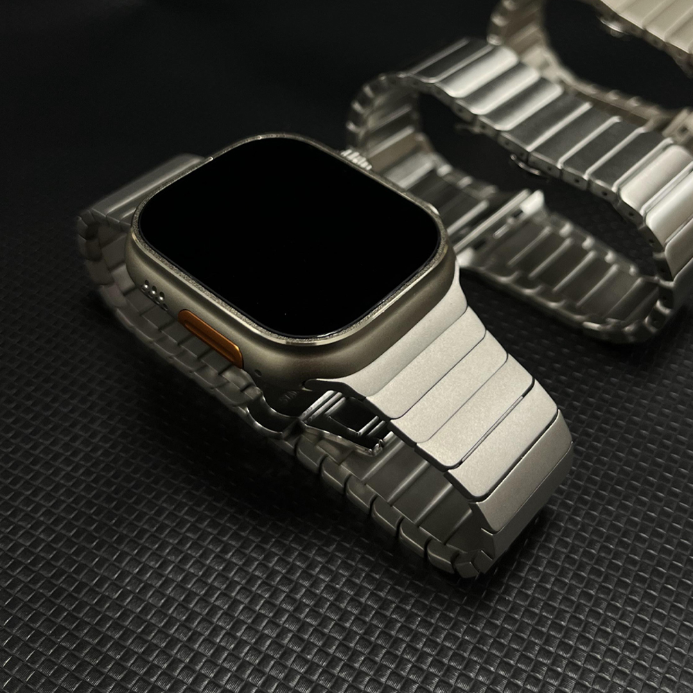 Stylish men's stainless steel smartwatch wristband on a male wrist, showcasing a modern and adjustable fit.
