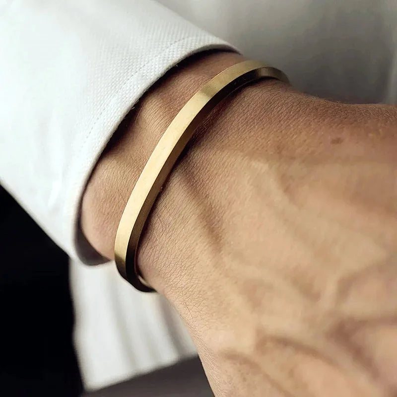 Sleek unisex minimalist stainless steel cuff bracelet, perfect for everyday wear. Adjustable for comfort.