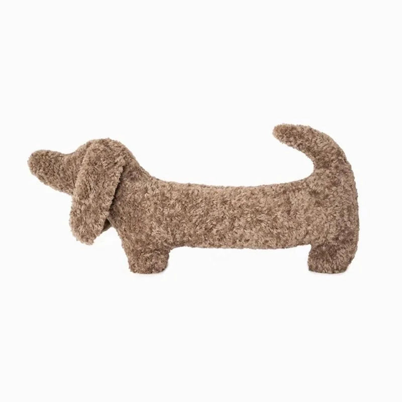 Camel-colored Dachshund plush animal pillow. Soft accent cushion for cozy home decor.