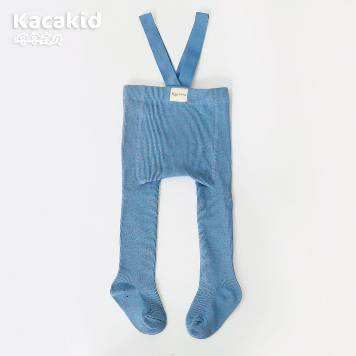 Happy baby wearing soft, high-waist knitted trousers. Comfortable infant clothing for daily wear.