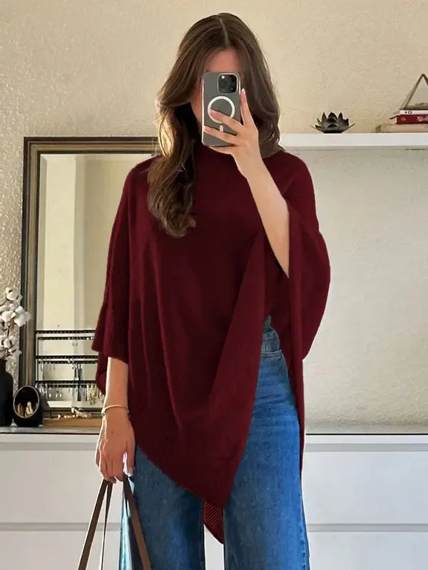 Women's soft knit poncho top with an elegant asymmetric cut. A cozy wool blend layering piece for fall style.