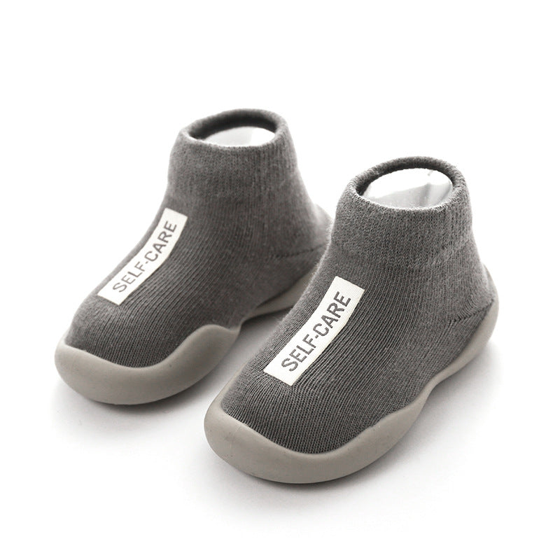 Cozy knitted anti-slip baby slippers ensuring warm feet and comfortable first steps for toddlers.